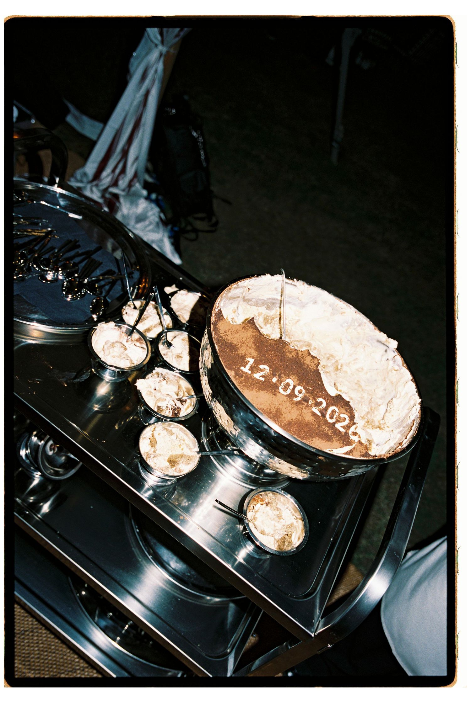 Wedding cake dated 12.09.2024 with meringue topping displayed on silver stand with individual portions.