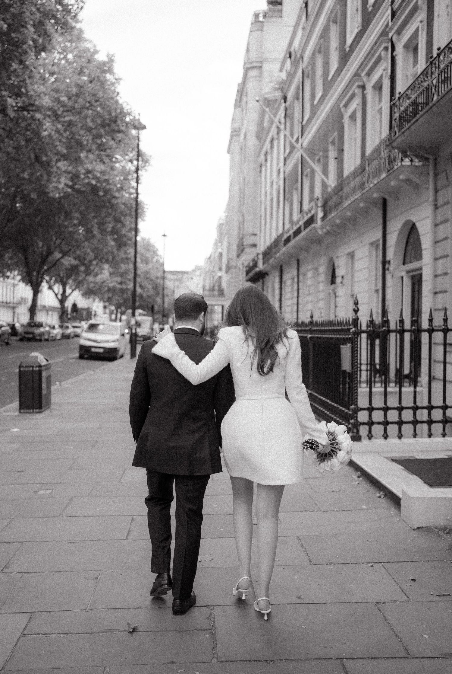 Black and white photo series showing a couple walking together down an elegant city street.