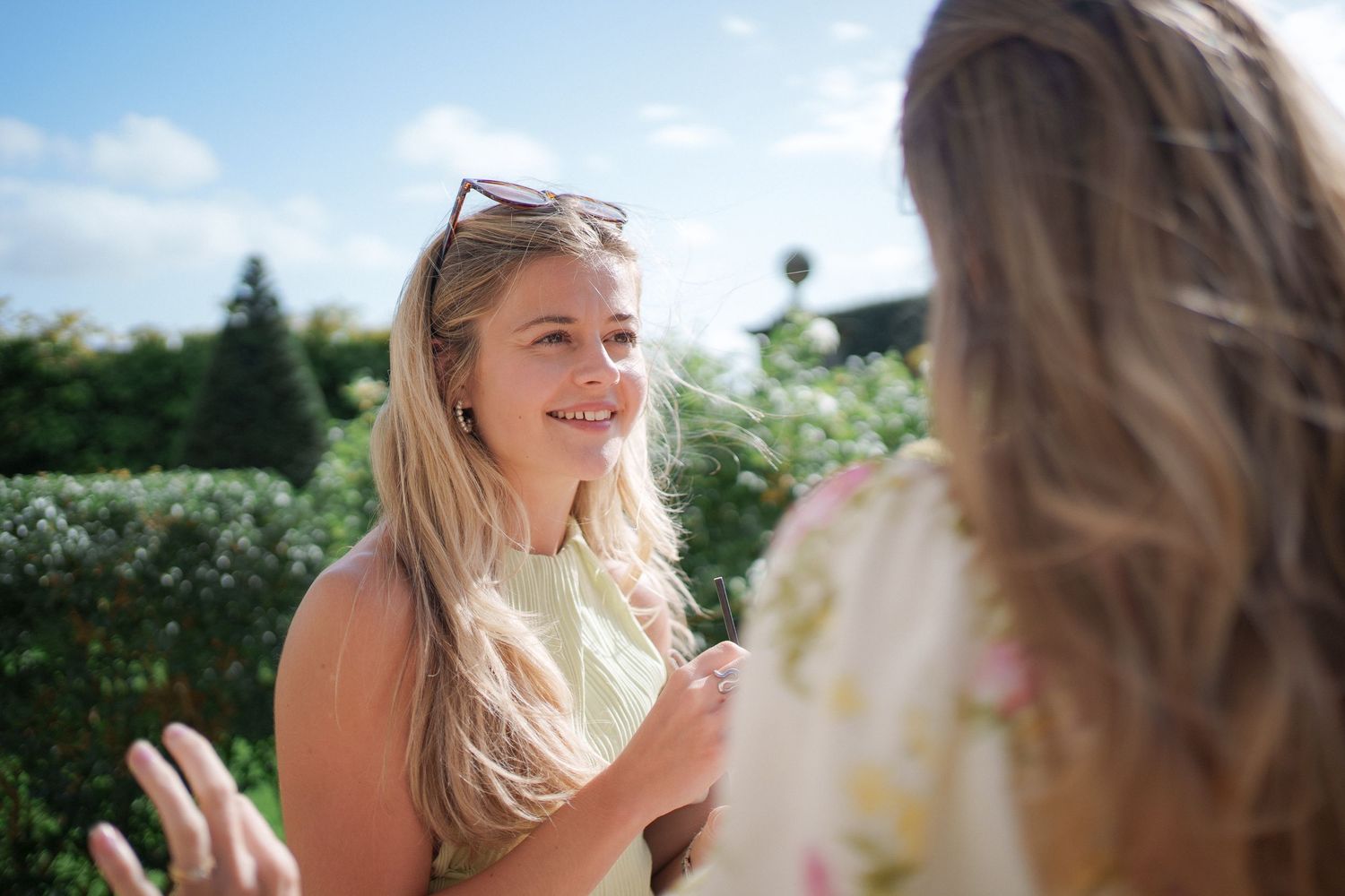 A series of candid outdoor portrait photos showing joyful expressions and natural light in a garden setting.