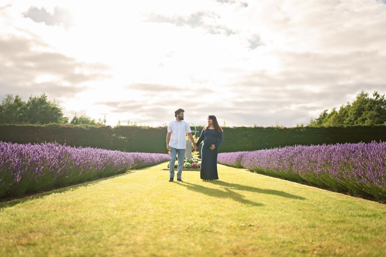 Family walking together through a blooming purple lavender field.