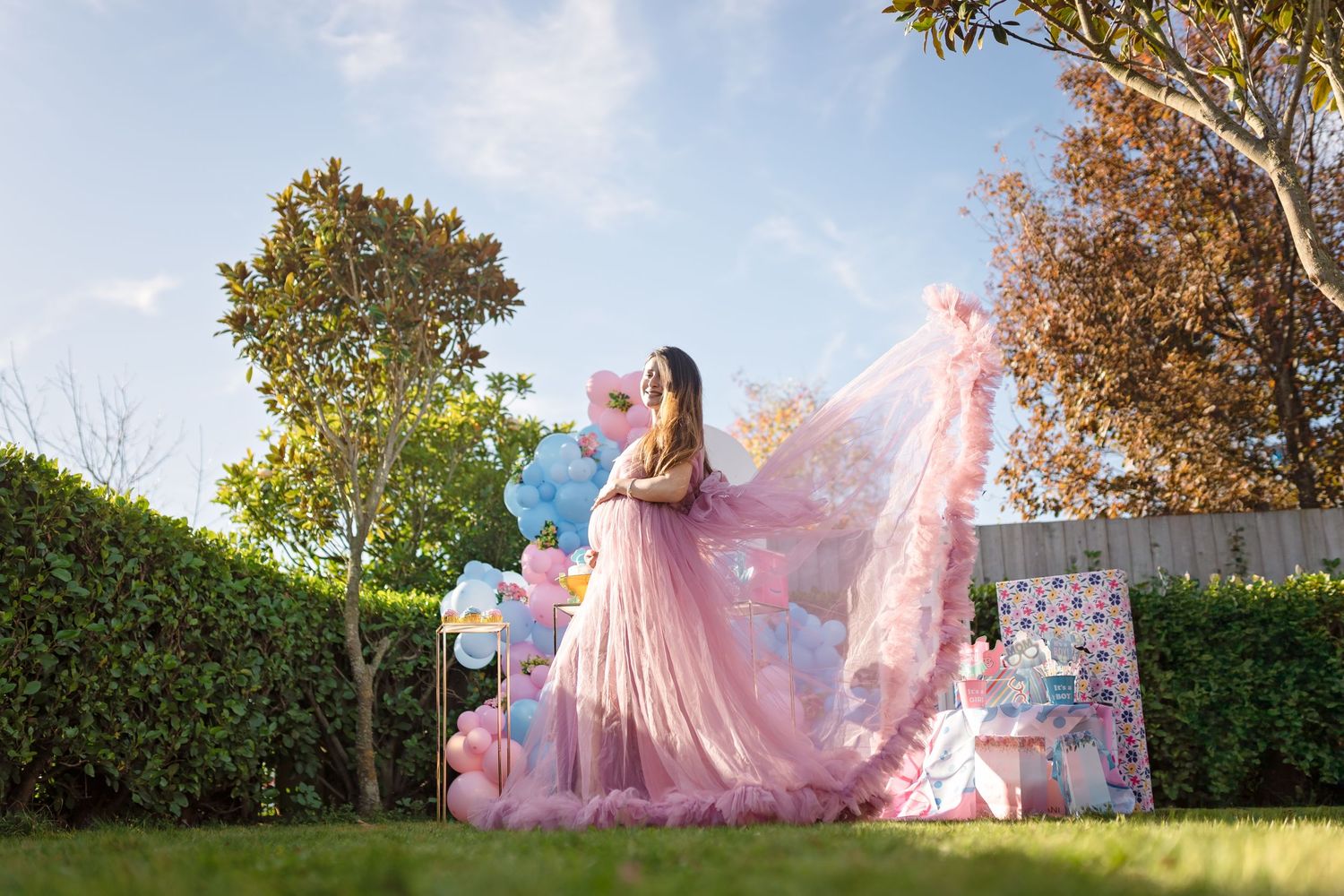 Seven sequential photos capture a pink dress billowing dramatically in a sunny garden setting against green hedges.