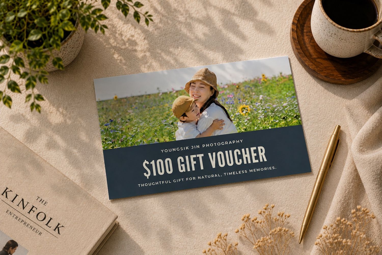 A $100 photography gift voucher card featuring a mother and child in a sunflower field, displayed on a neutral background.