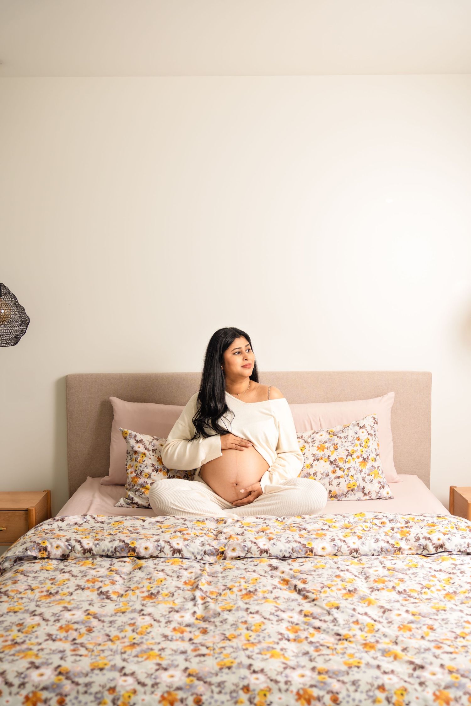 A sequence of photos shows someone reclining on a floral print bedspread in different relaxed poses.