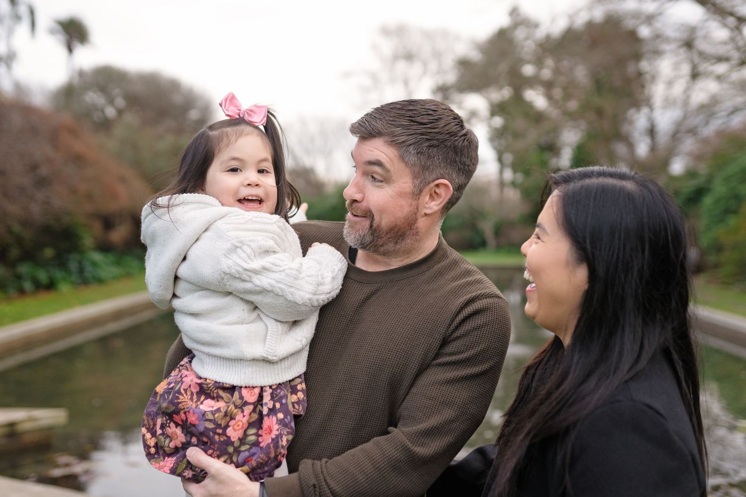 A series of outdoor family photos showing candid moments between parents and child during a fall photo session.