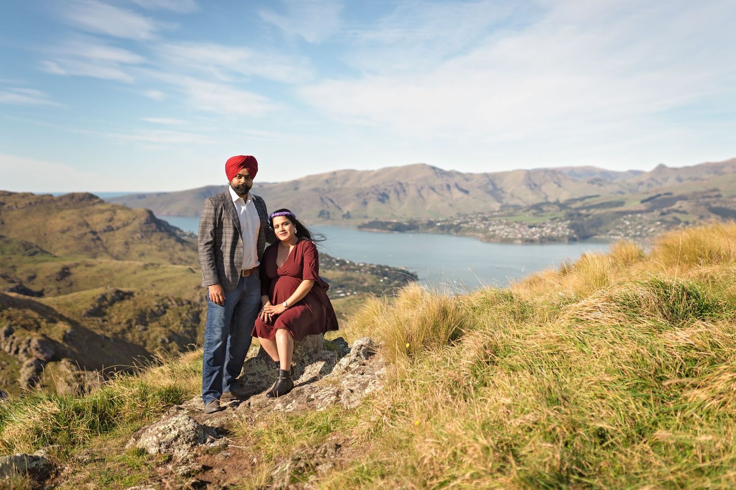 Hikers enjoy scenic views from hilltop trails overlooking Banks Peninsula and Akaroa Harbor in New Zealand.