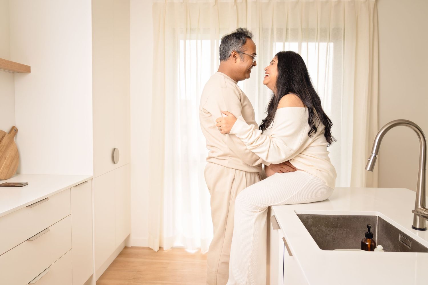 Sequence of romantic images showing couple sharing intimate moments in bright, white home interior.