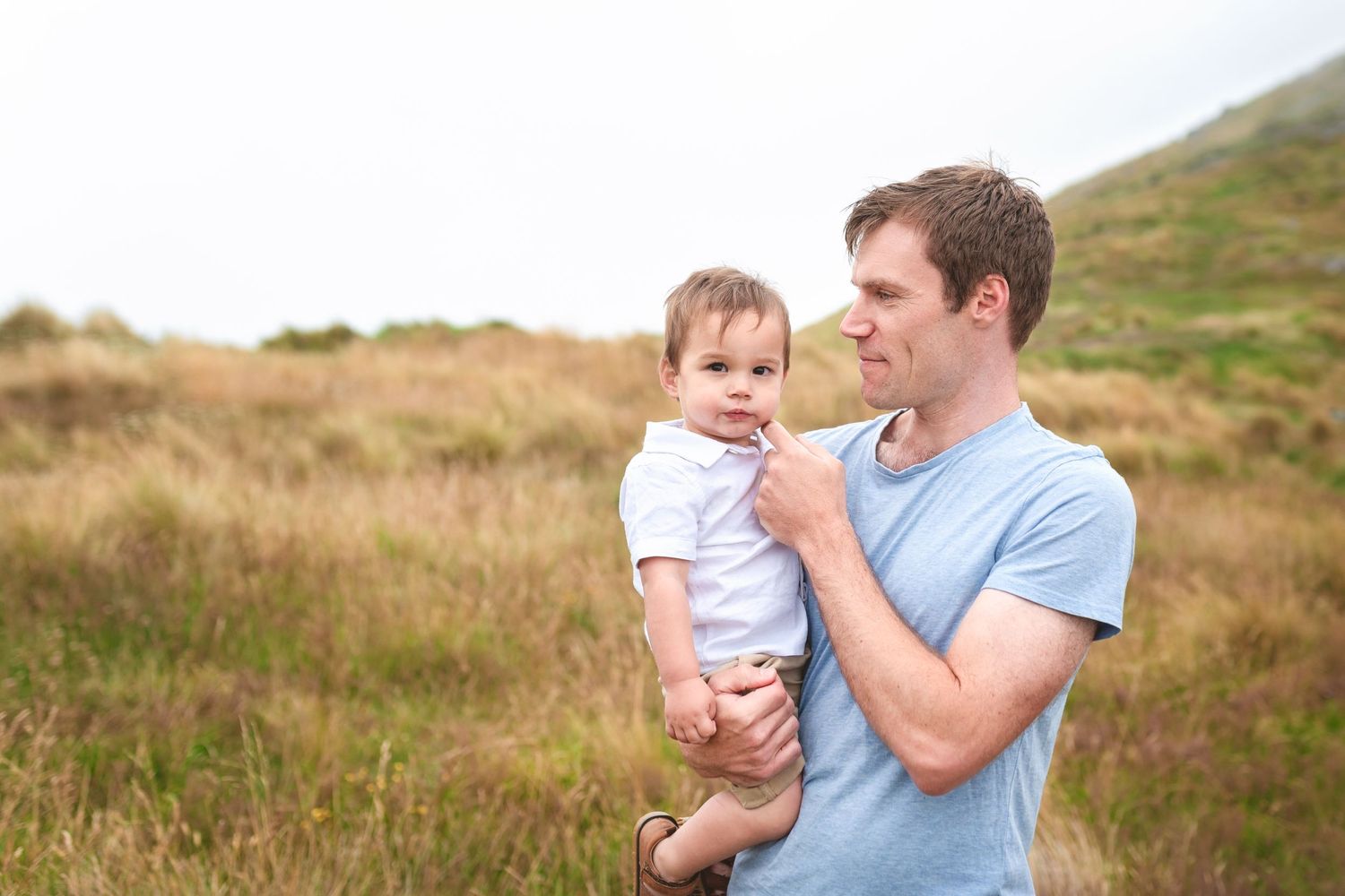 Tender moment shared between two people against natural mountain backdrop.