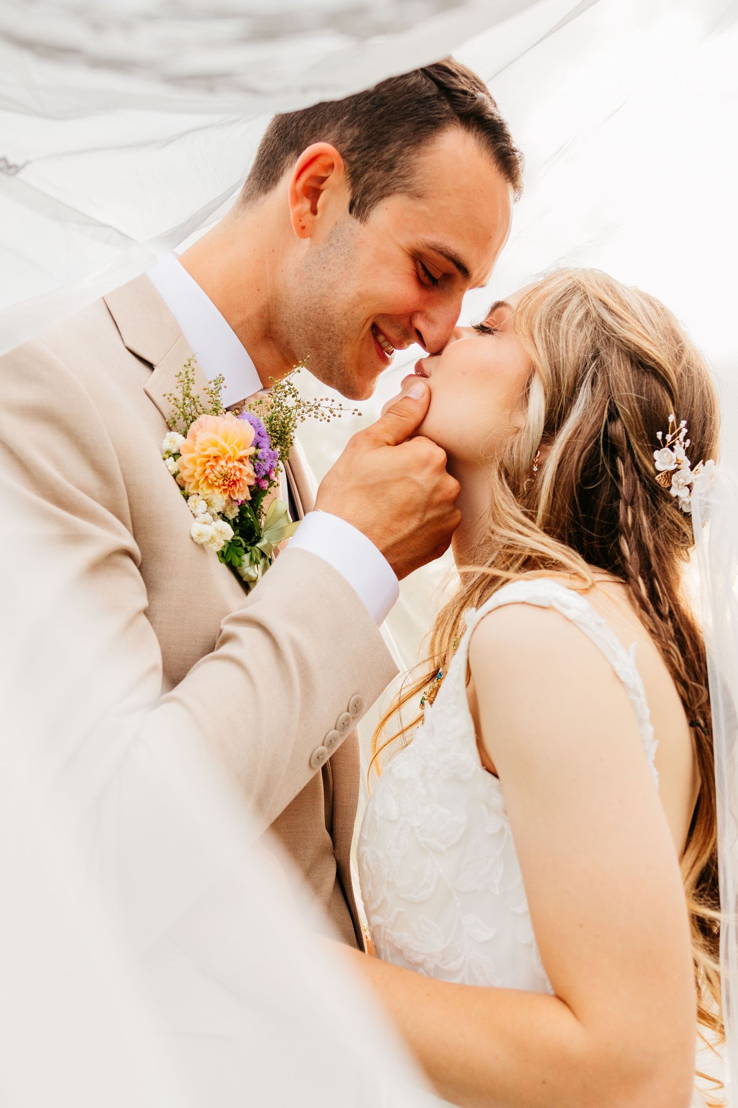Romantic newlyweds share intimate moments in a series of tender wedding photos showing their first kiss as a married couple.