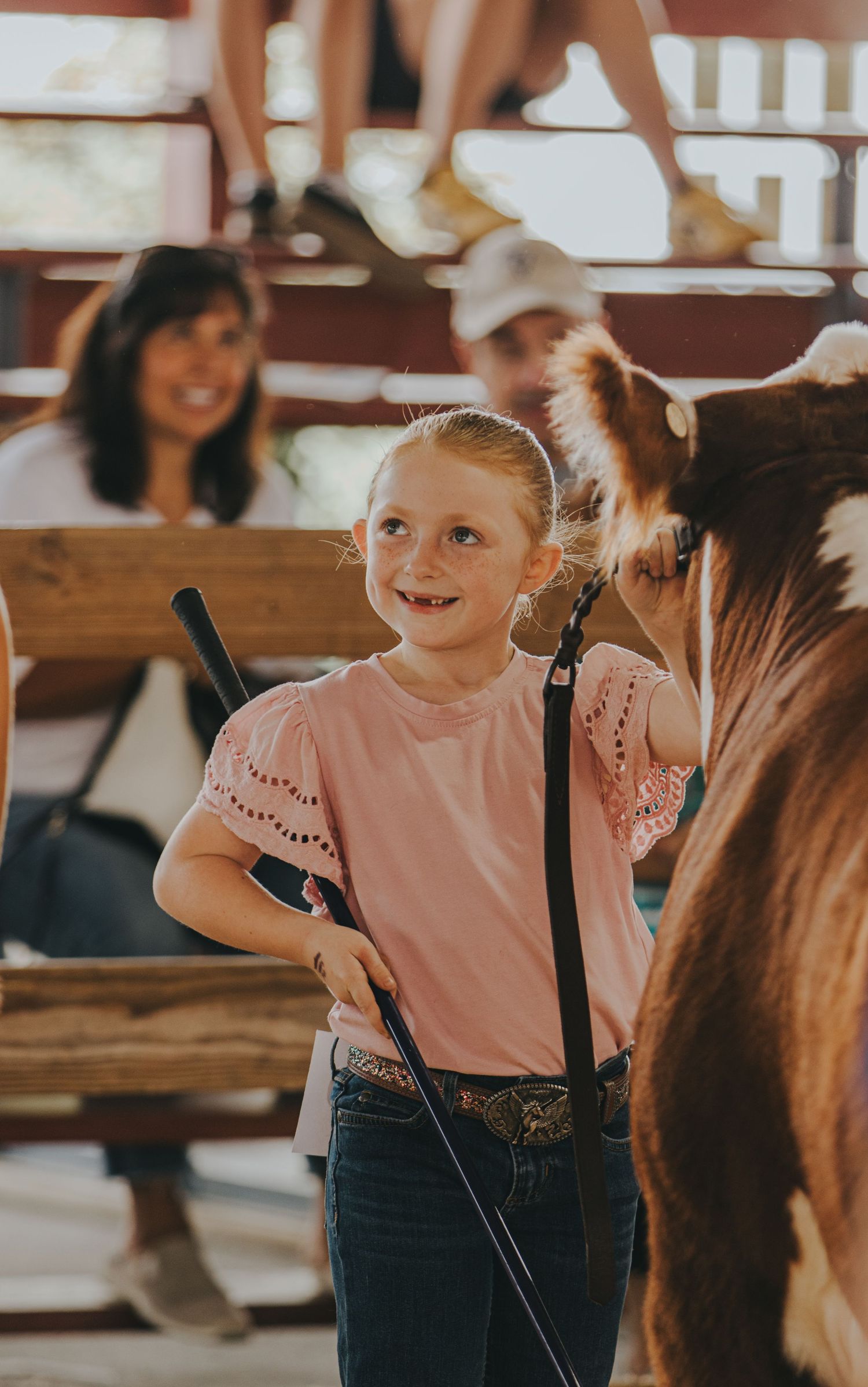 Young participants showing livestock at a county fair or agricultural event.