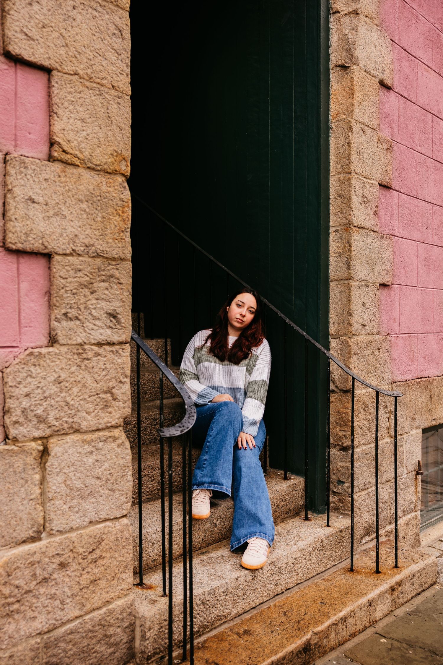 A sequence of photos showing someone in denim sitting on stone steps against a pink and beige wall.