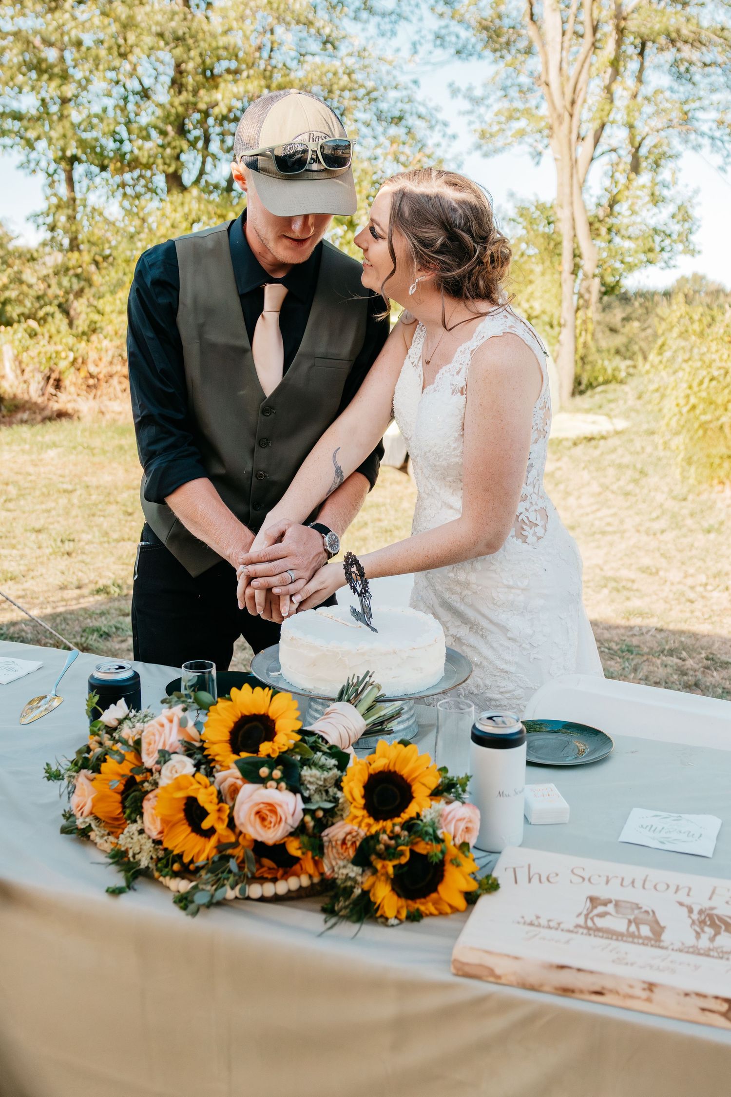 Newlyweds sign their marriage certificate with sunflower decorations on the signing table.