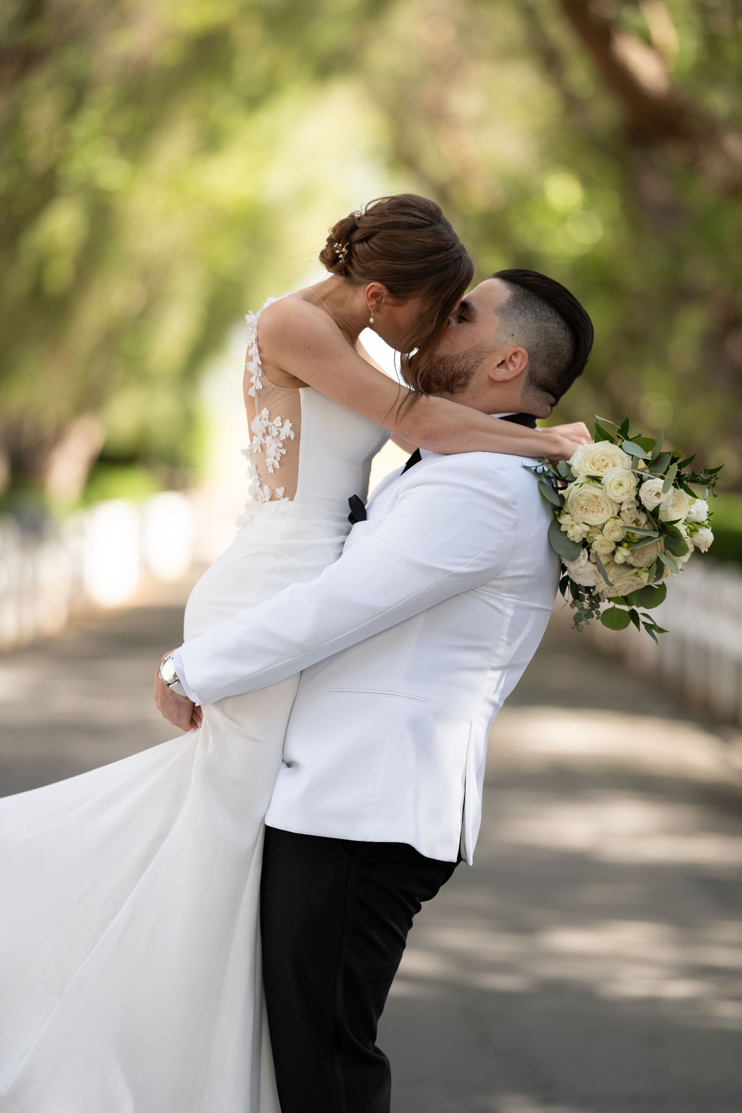 A romantic embrace during an outdoor wedding photoshoot.