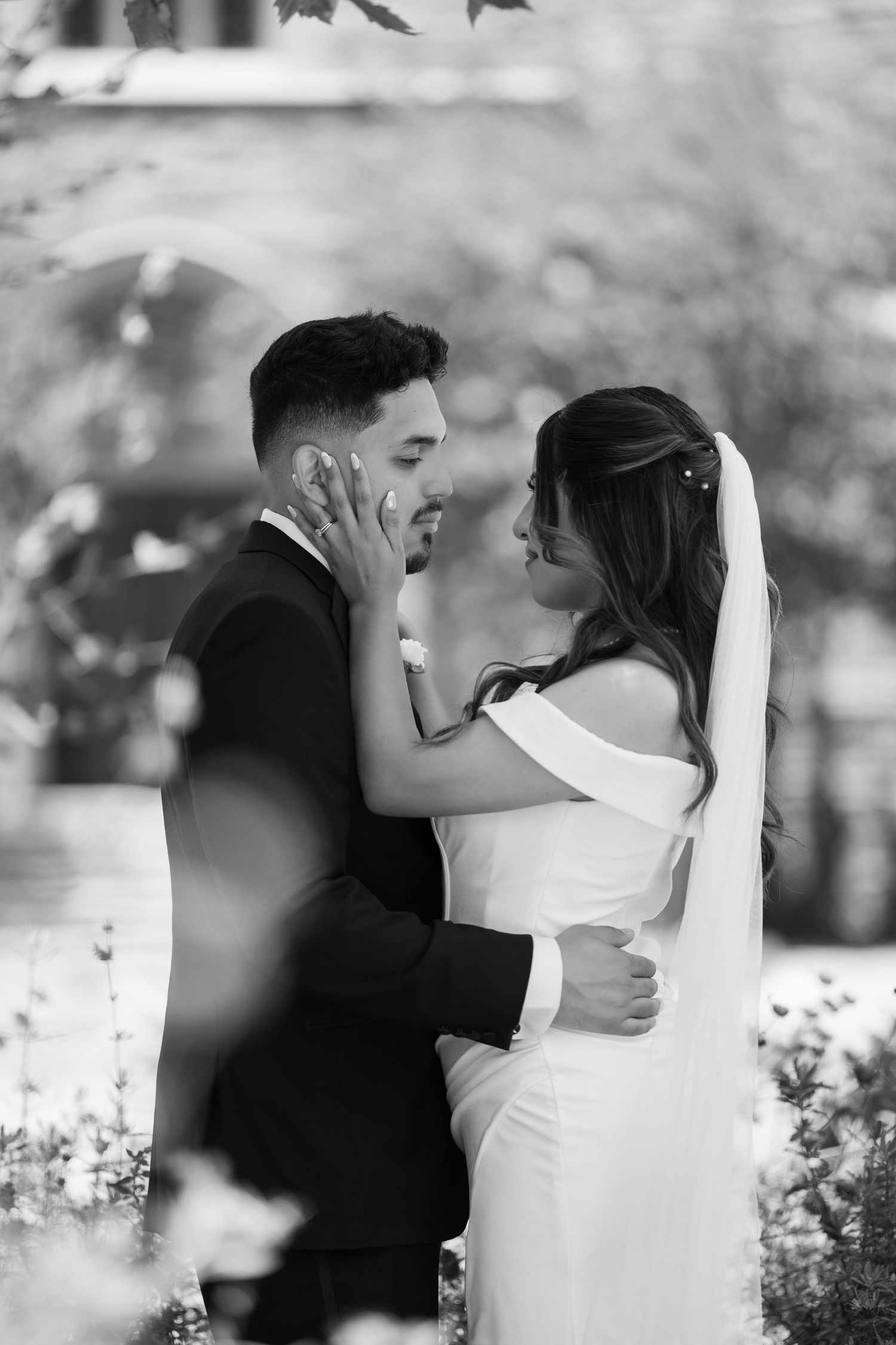Black and white romantic wedding portraits in a garden setting.