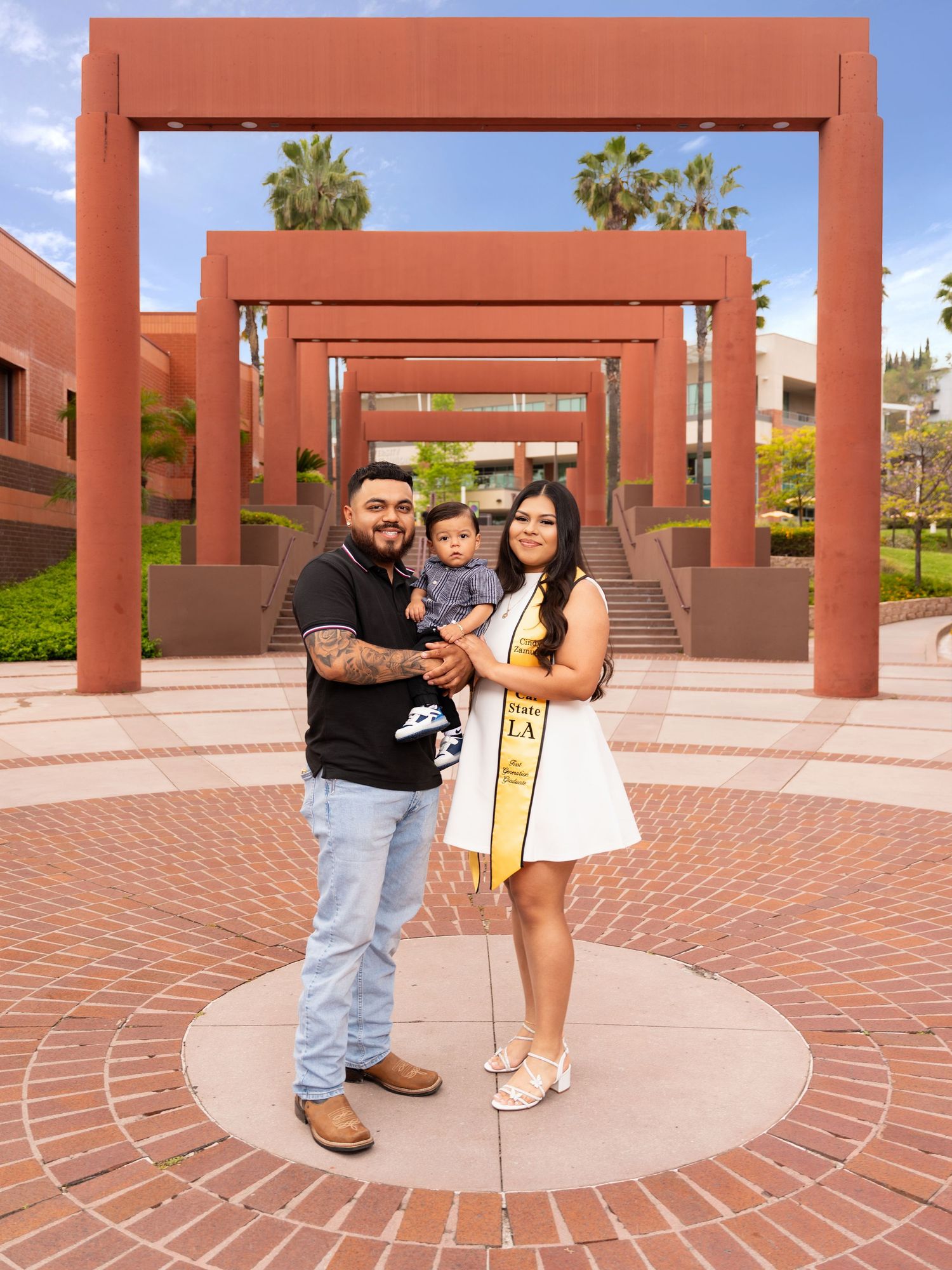 A couple poses for a series of four photos in a brick-paved courtyard with terracotta-colored architectural columns.