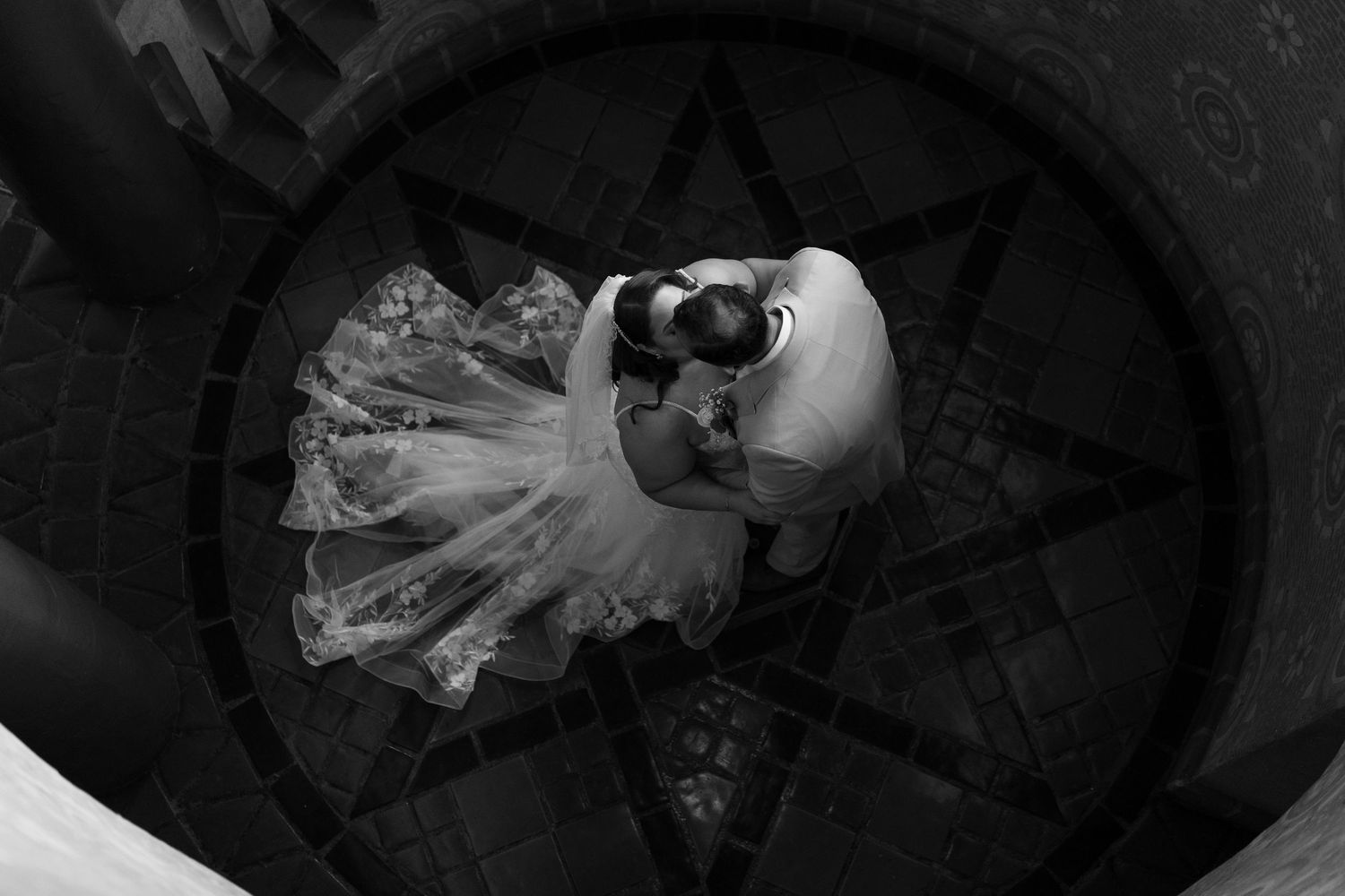 Artistic black and white perspective of couple dancing viewed from above.