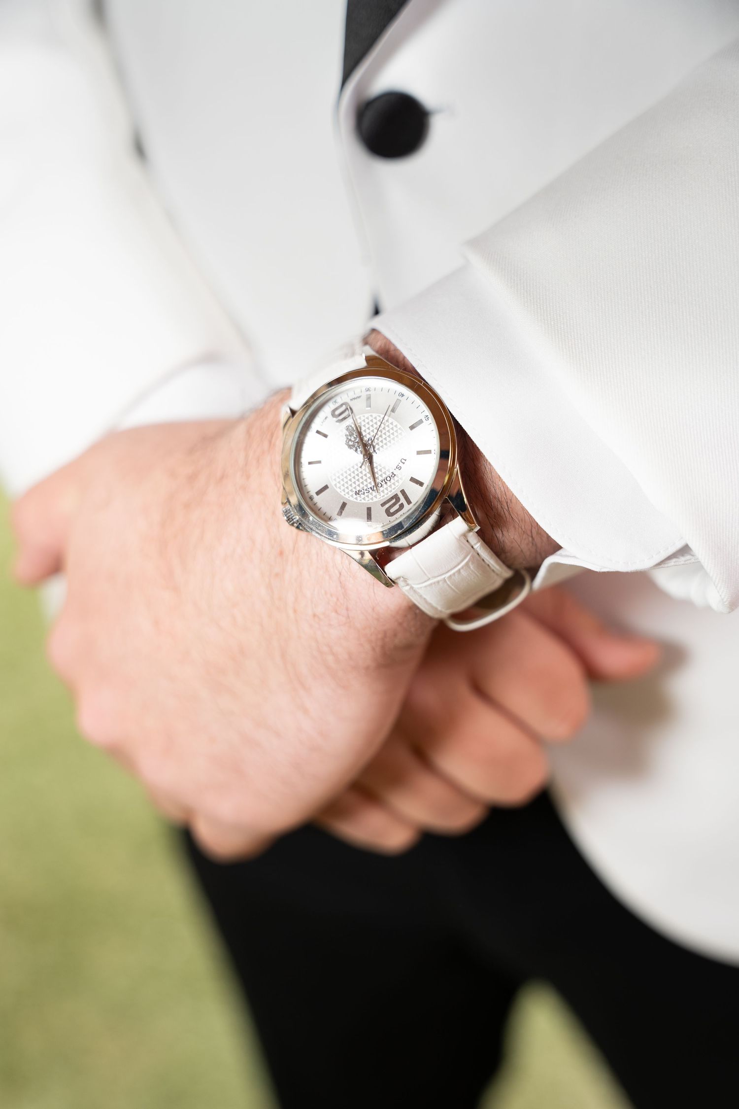 Close-up of an elegant silver wristwatch against a white background.