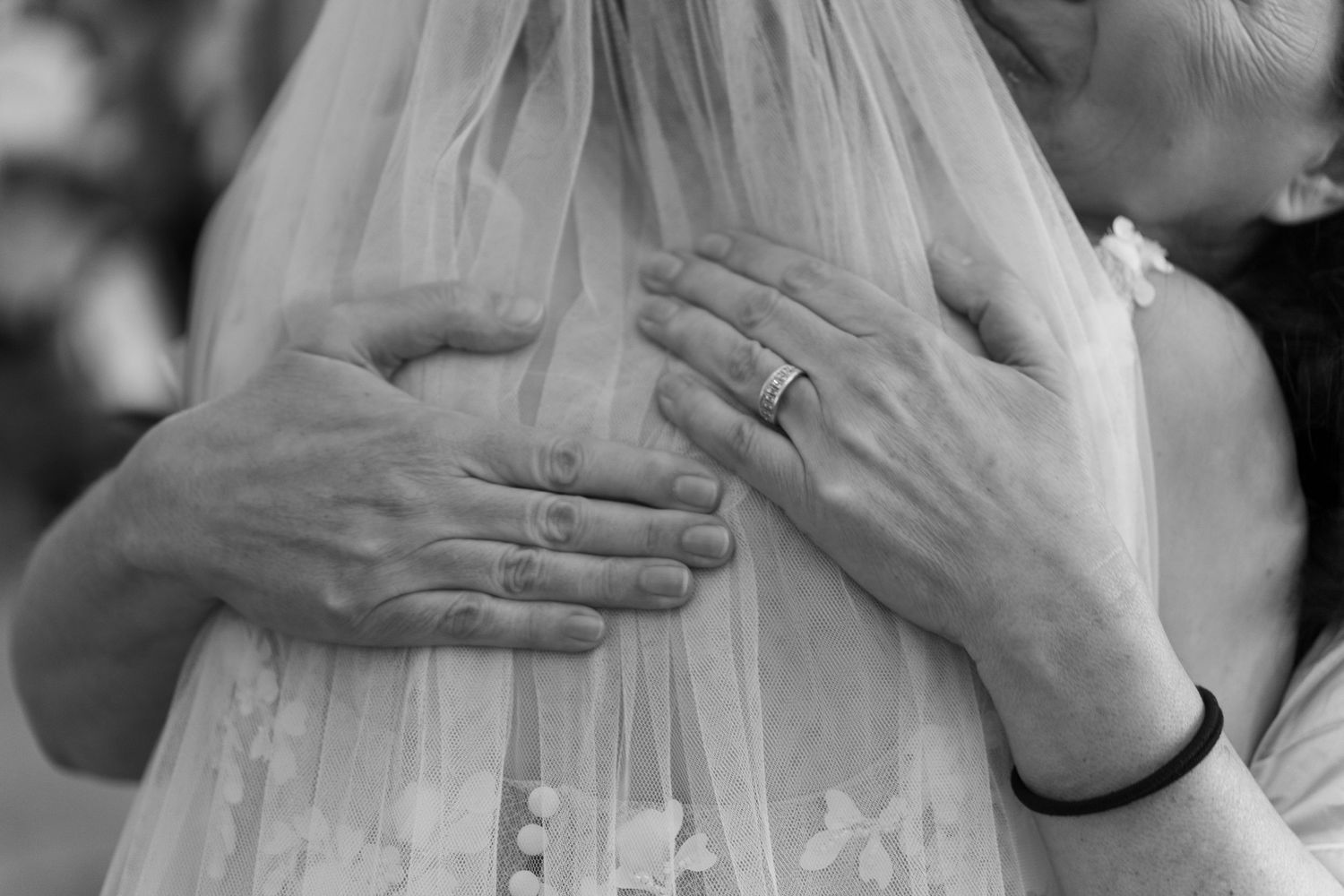 Intimate wedding ceremony moment captured in black and white photography.