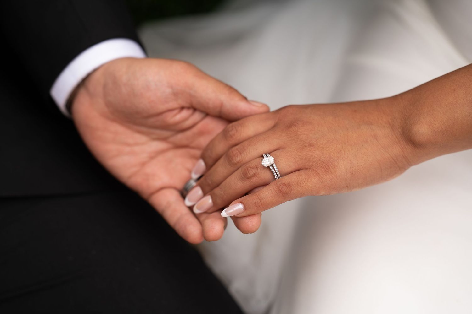 Close-up shot of hands exchanging rings during a wedding ceremony.