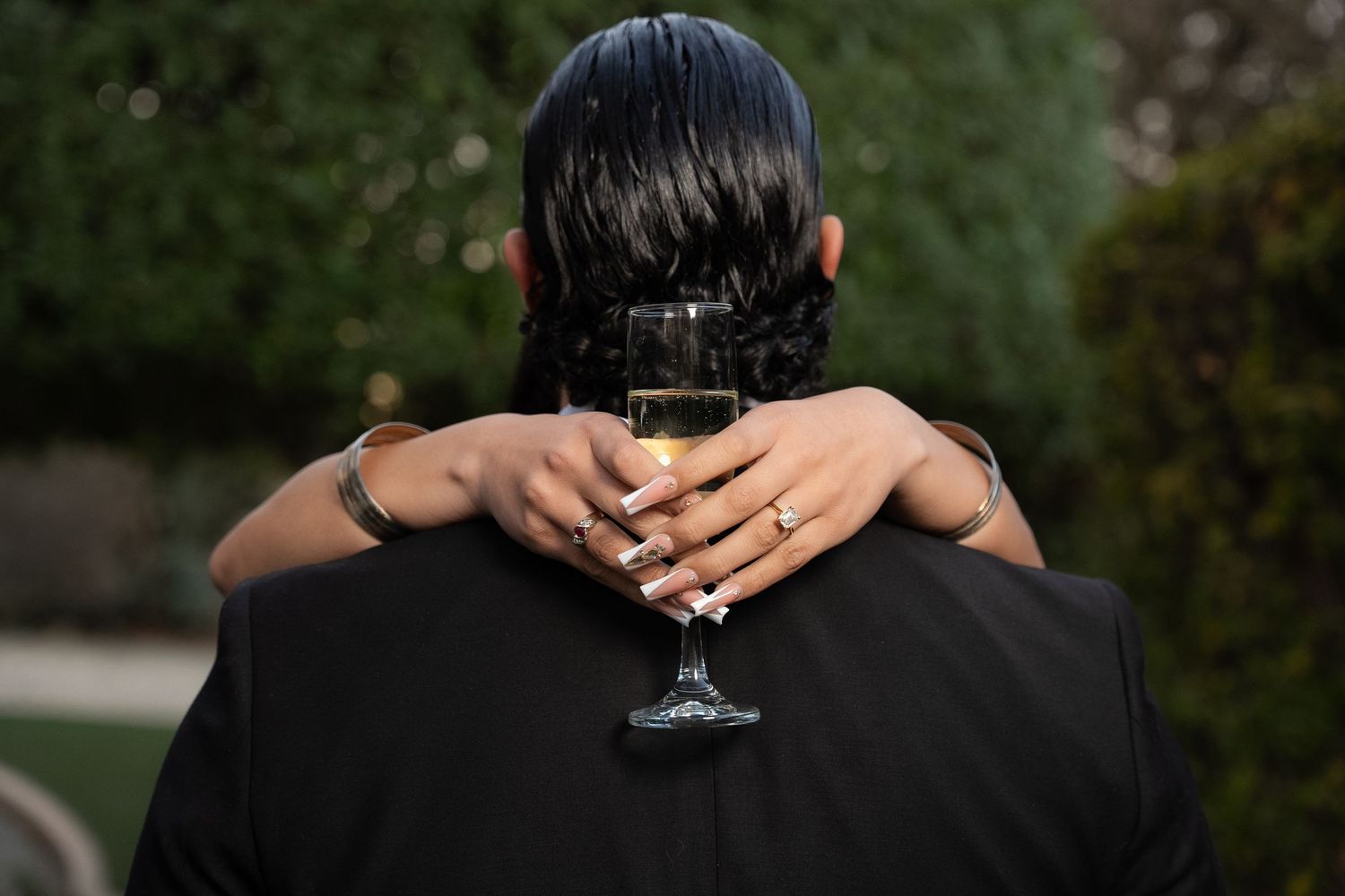 Close-up photos of a couple's hands and back of heads during an intimate outdoor engagement photo session.