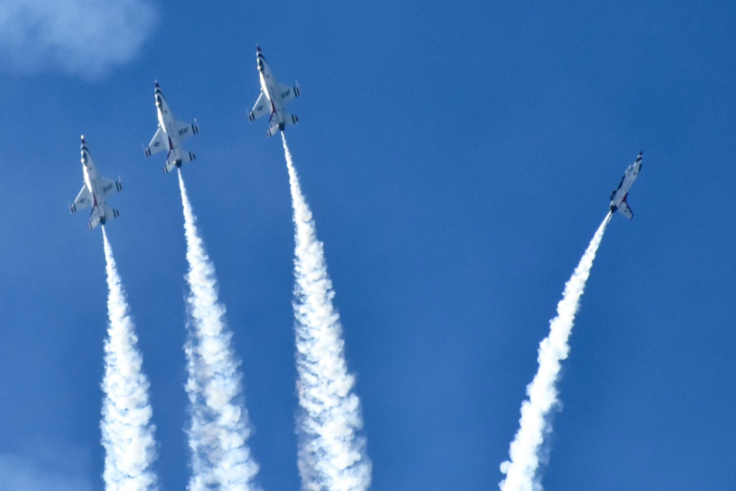 The US Air Force Thunderbirds perform astonishing maneuvers at an air show.