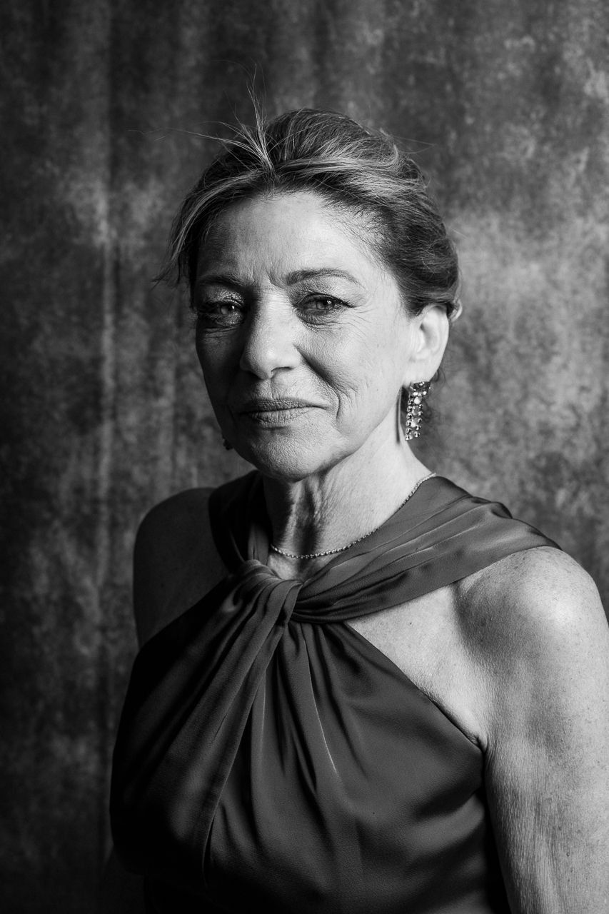 Dramatic black and white portrait series showing a woman in dark clothing against textured background.