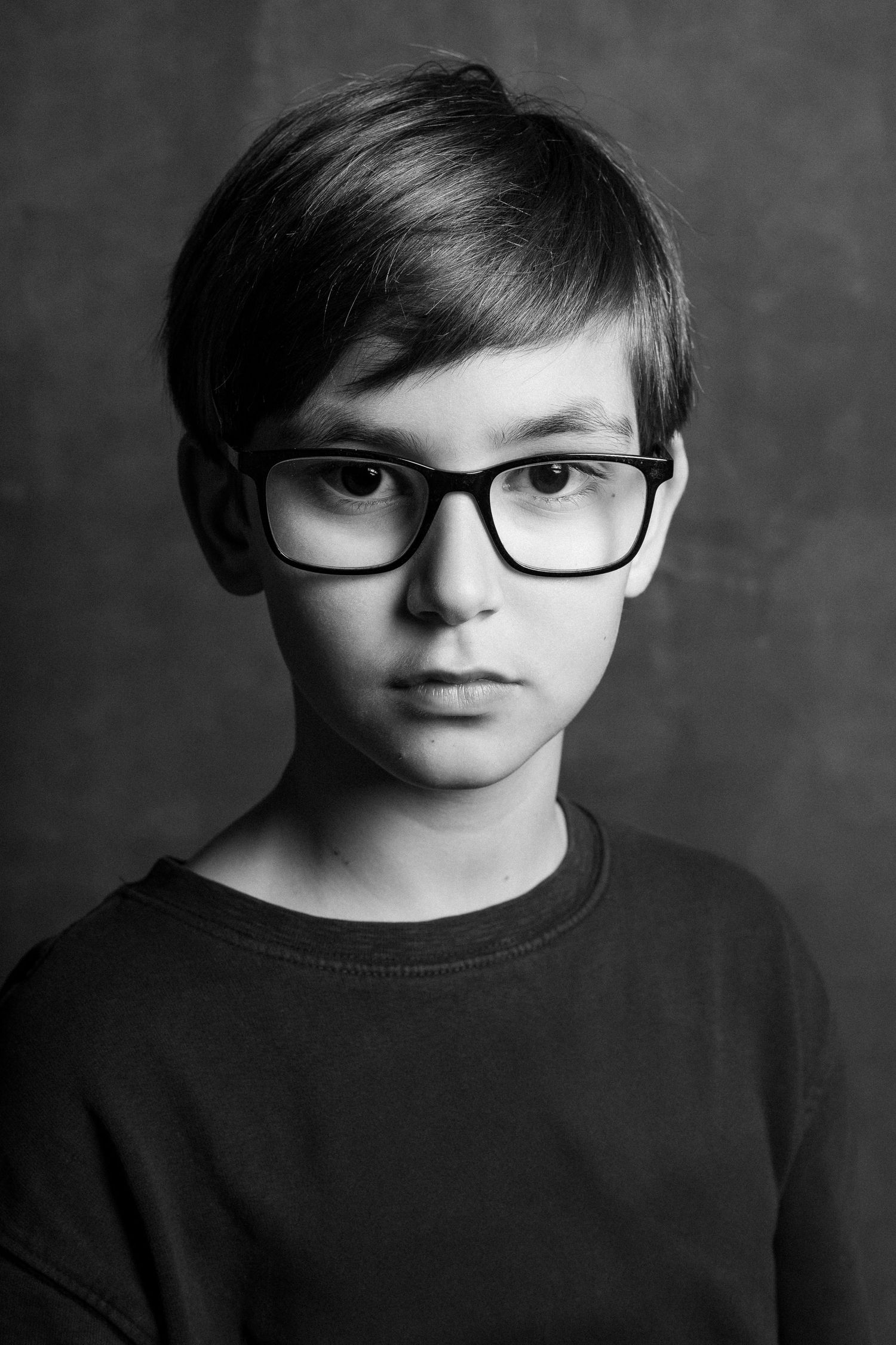 Black and white portrait series showing youth wearing glasses and dark clothing.