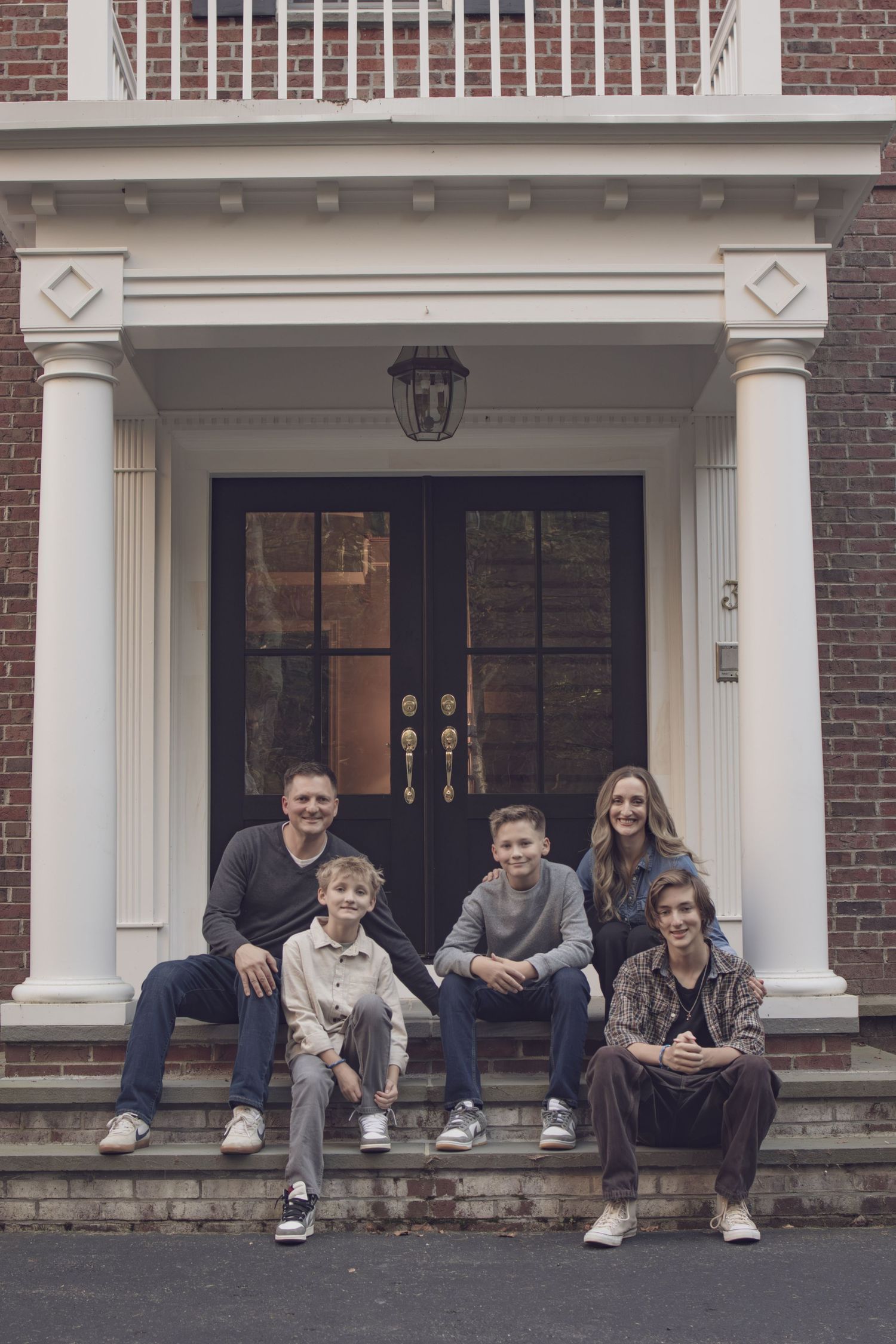 Fall family session in Andover featuring parents embracing their children during a warm, natural outdoor portrait.