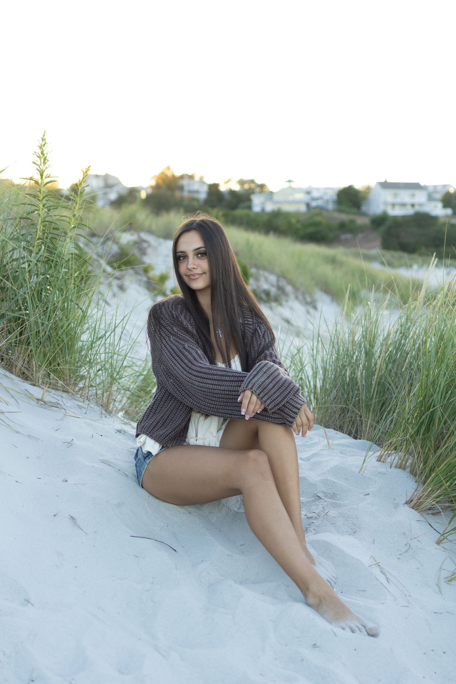 Senior posing at the dunes and high grass at beach in Gloucester.