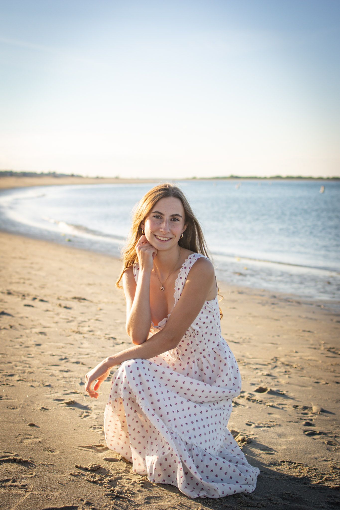 Senior posing for a photo at Crane beach in Ipswich, MA.