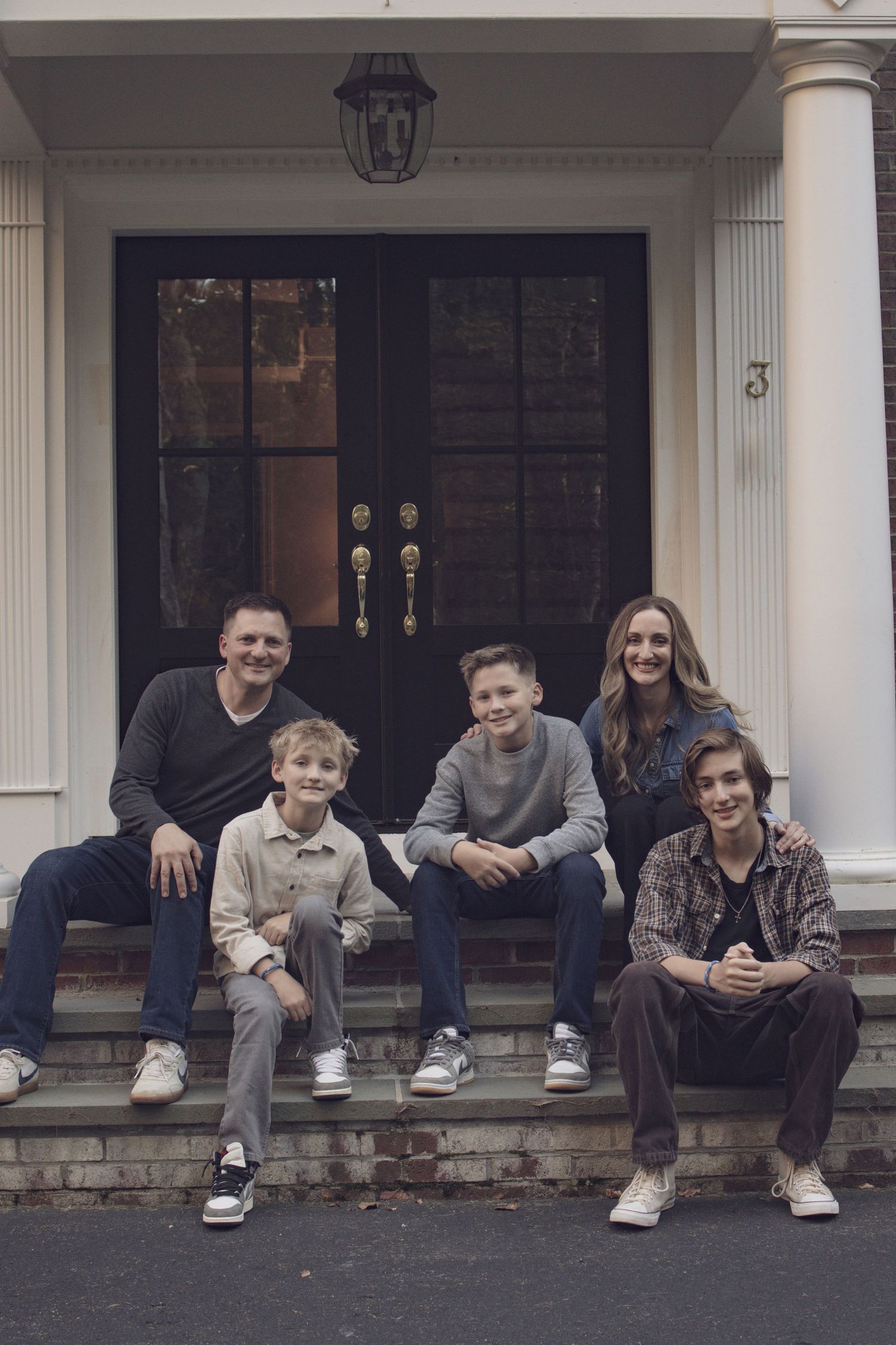 Fall family session in Andover featuring parents embracing their children during a warm, natural outdoor portrait.