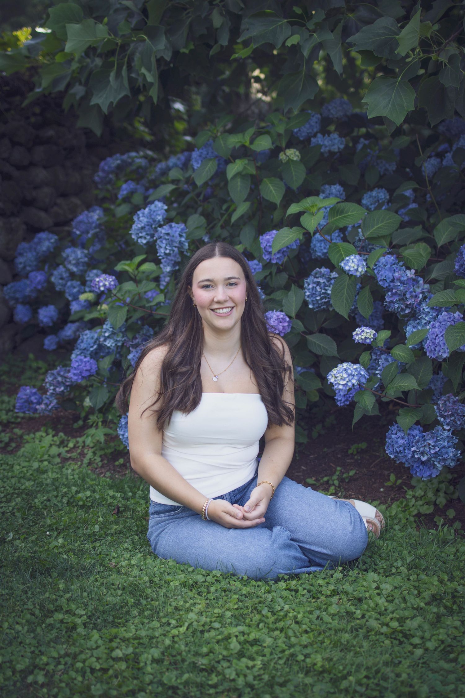 High school senior smiling during outdoor portrait session in Andover, MA