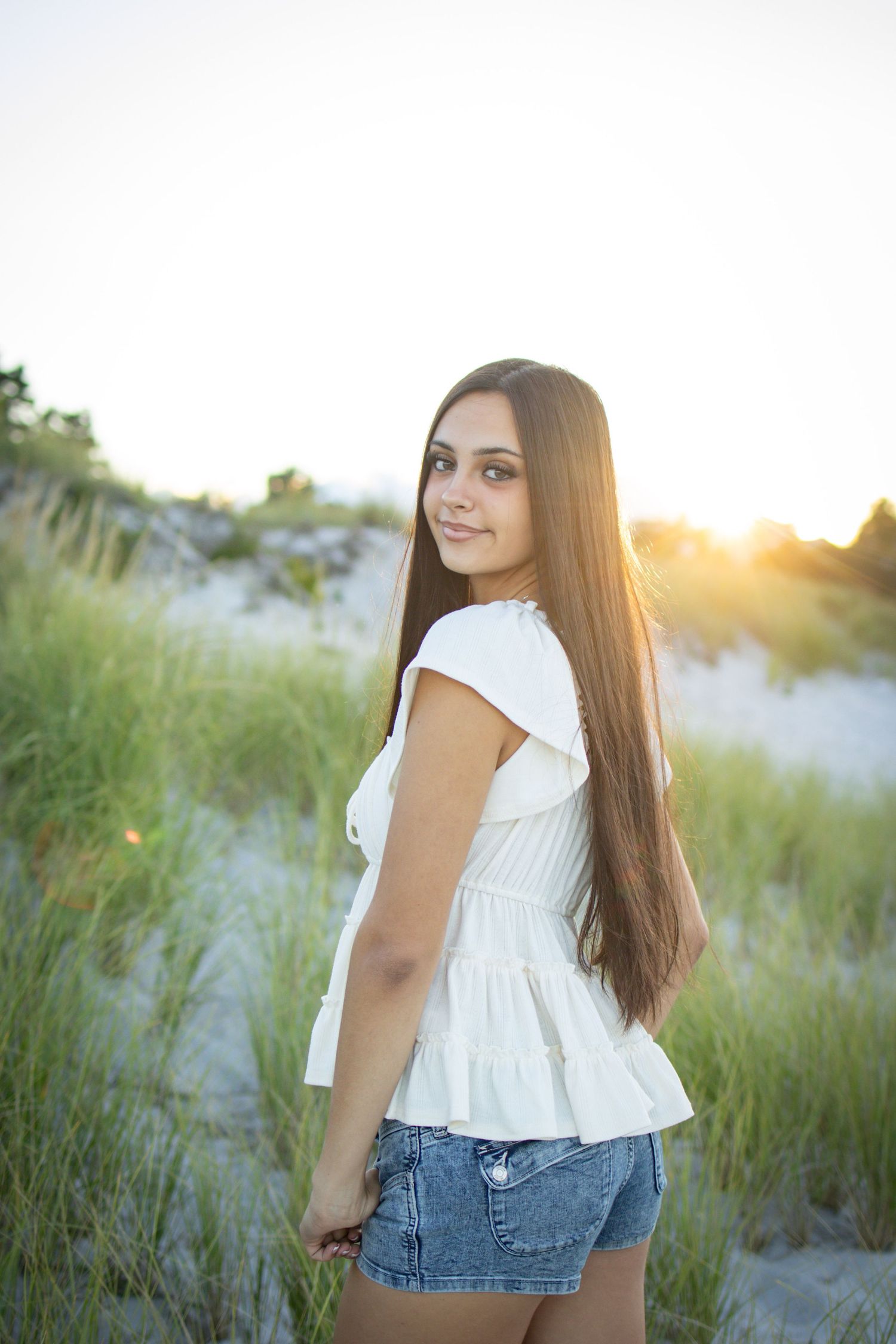 Senior posing at the dunes and high grass at beach in Gloucester.