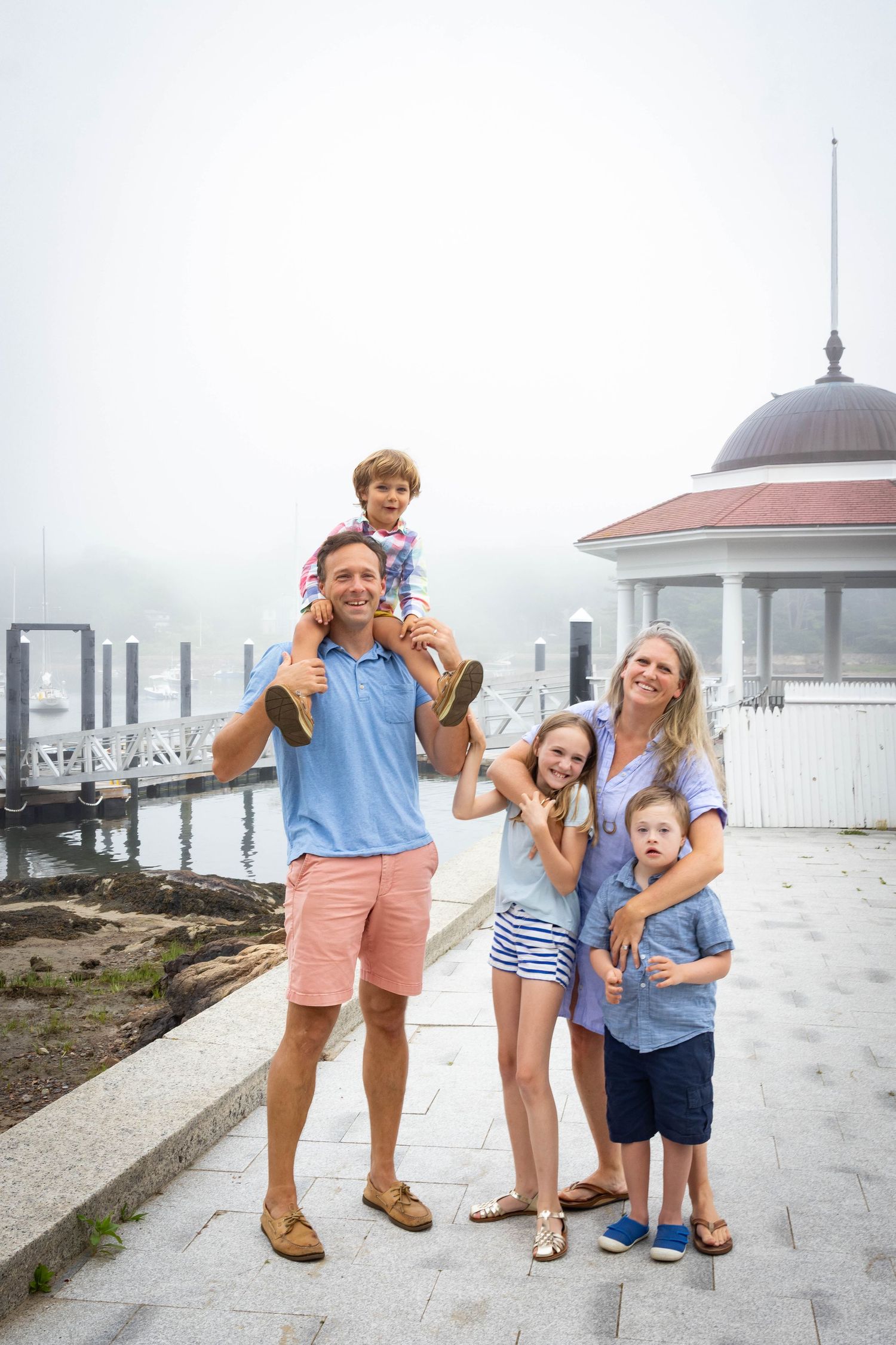 Family posing for a photo in front of the gazebo at Tucks Point in Manchester-by-the-sea.