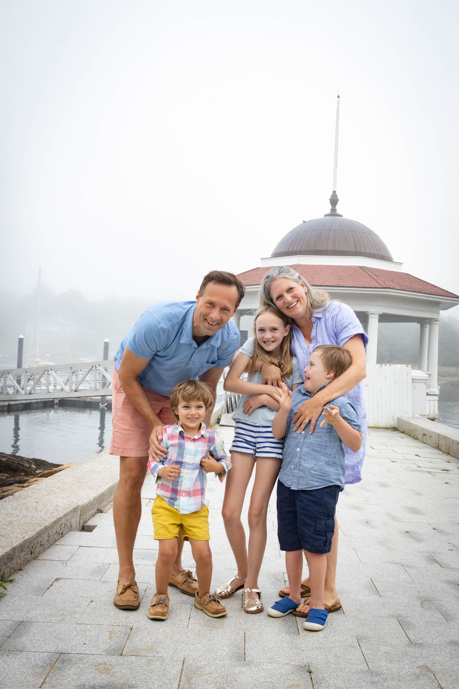Family posing for a photo in front of the gazebo at Tucks Point in Manchester-by-the-sea.