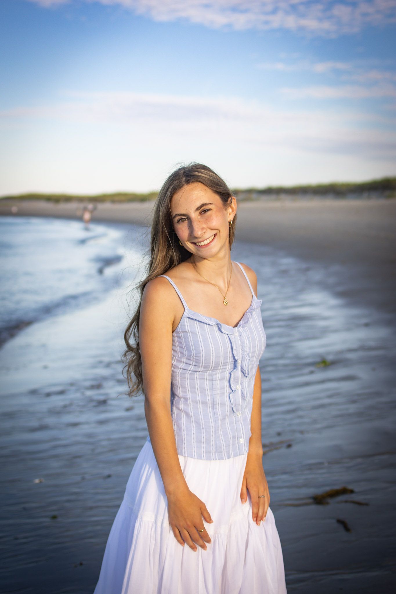 Senior posing for a photo at Crane beach in Ipswich, MA.