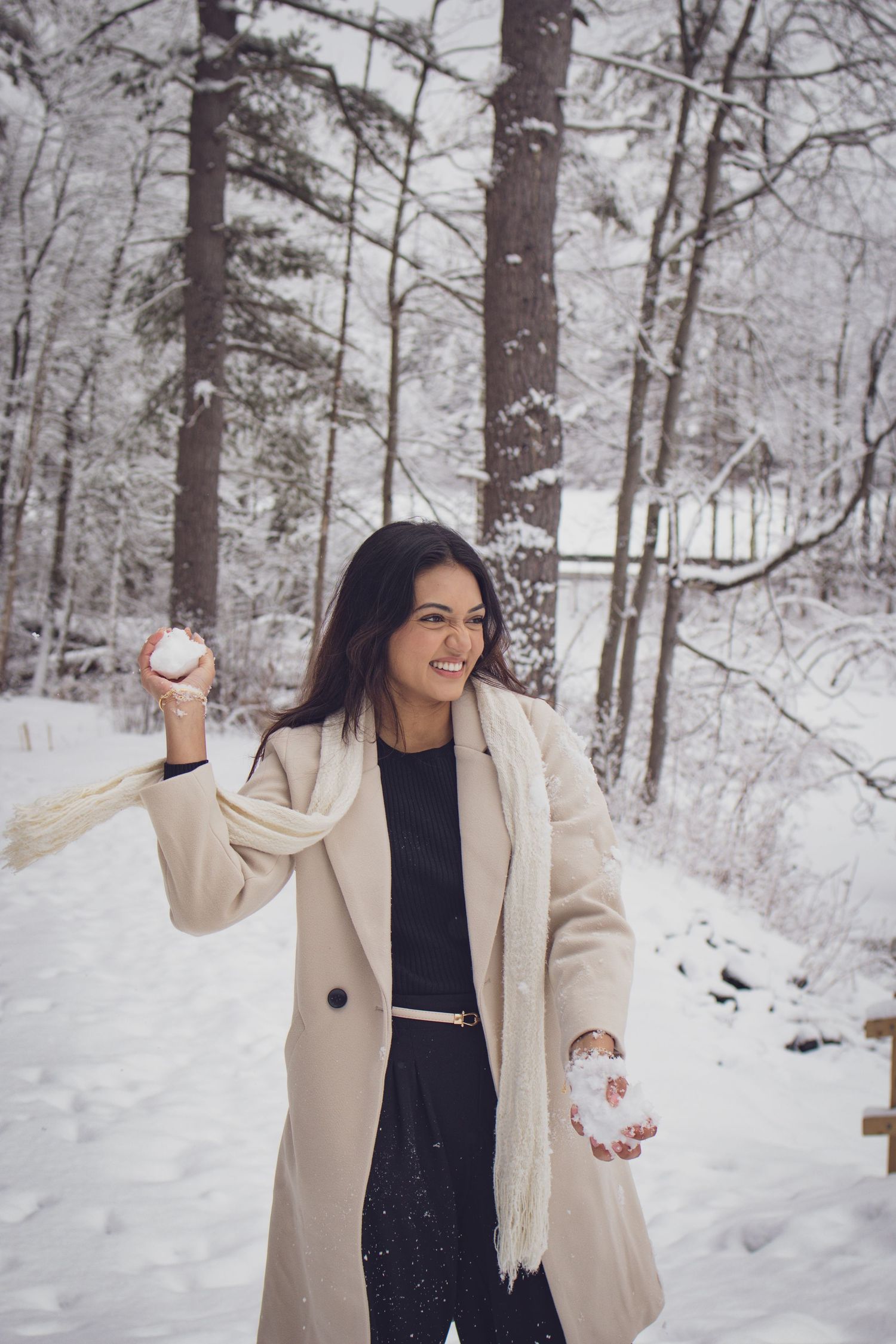 Andover couple photographer capturing a romantic winter session of a couple holding hands and walking through falling snow.