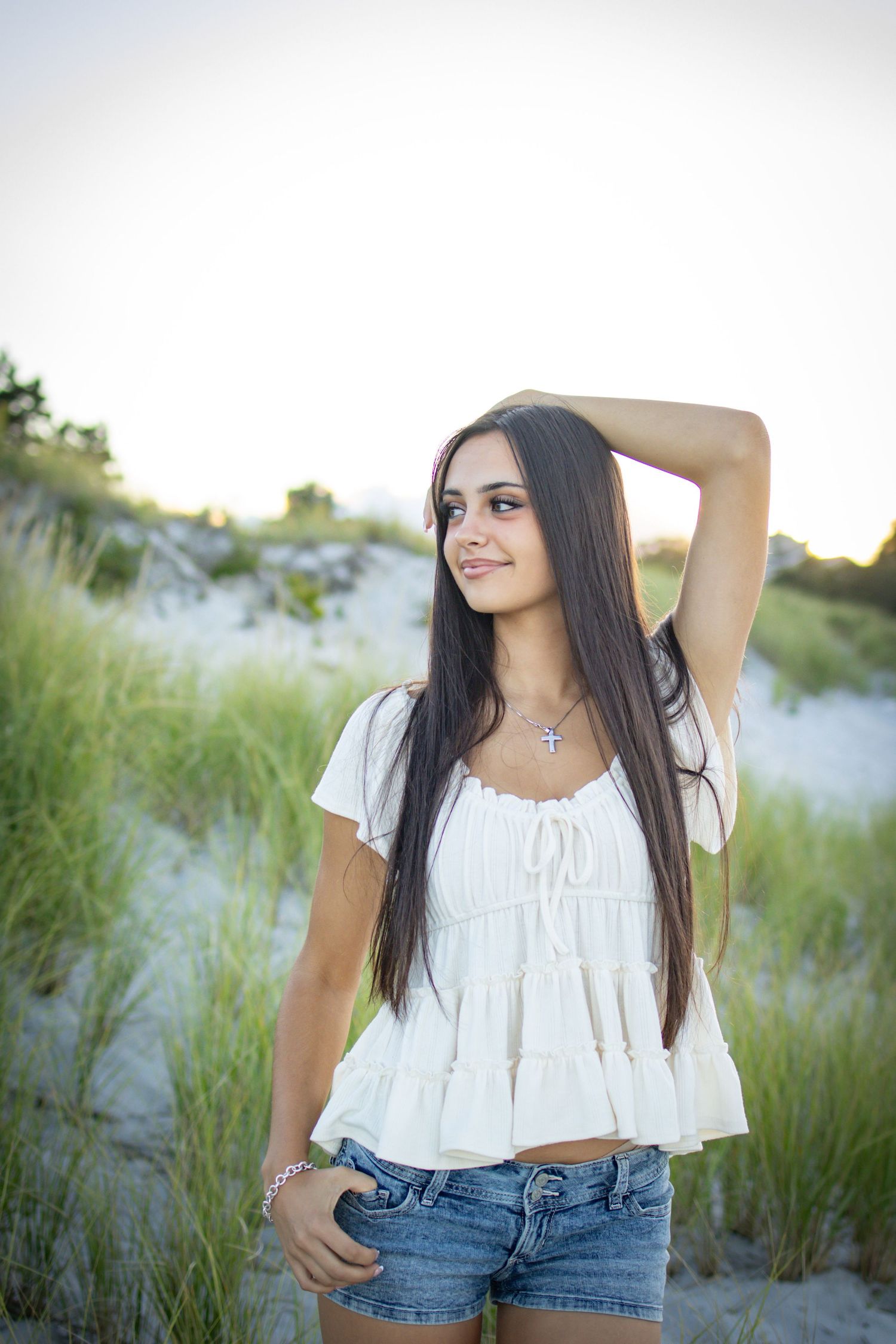 Senior posing at the dunes and high grass at beach in Gloucester.