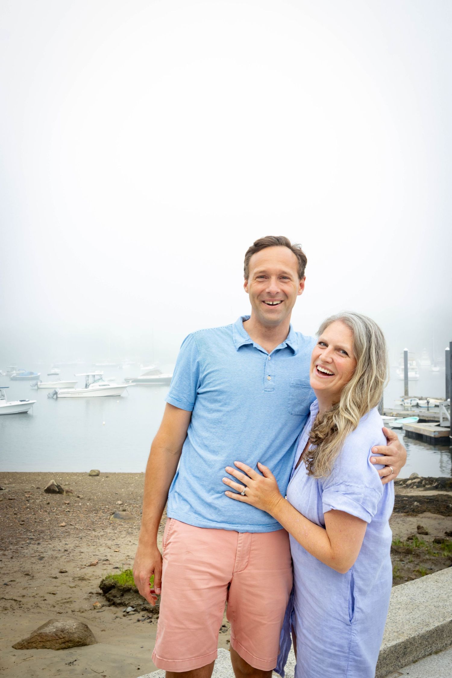 Mom and dad holding for a photo in Manchester-by-the-sea.