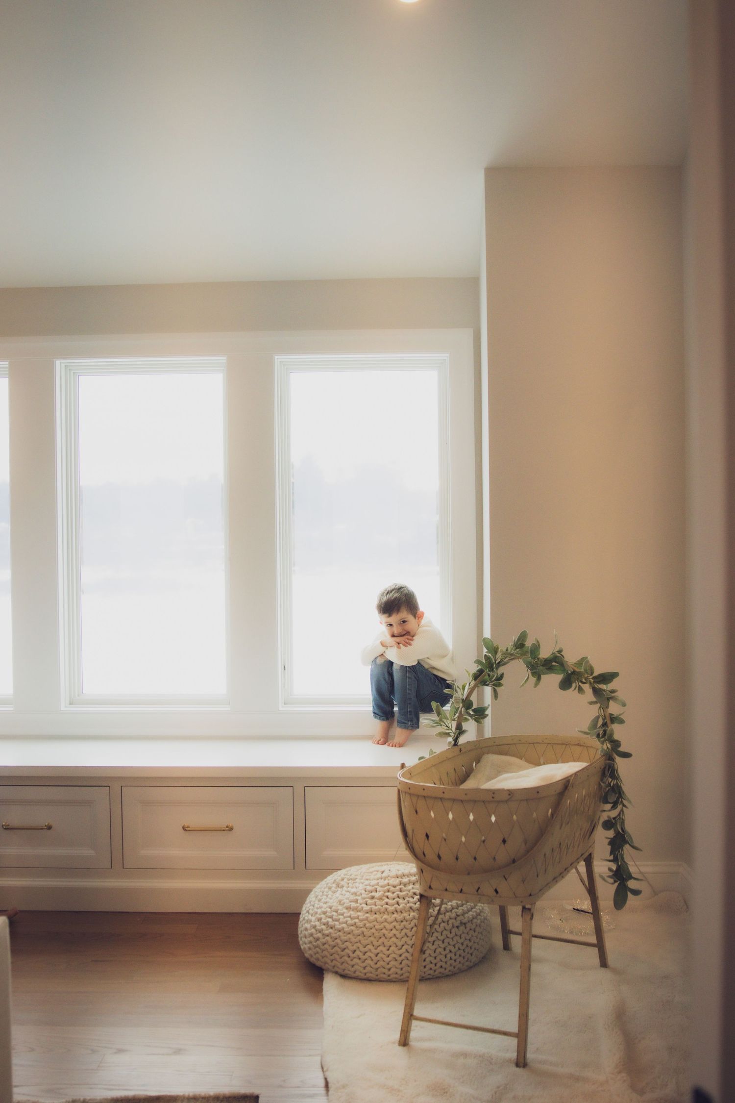 Big brother playfully hiding from the photo in their home in Andover