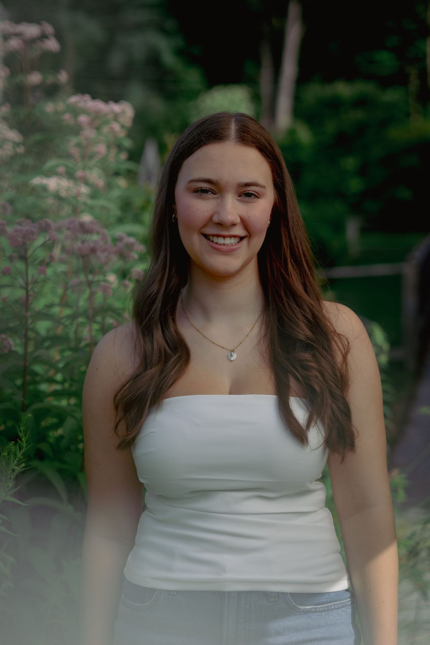 High school senior smiling during outdoor portrait session in Andover, MA
