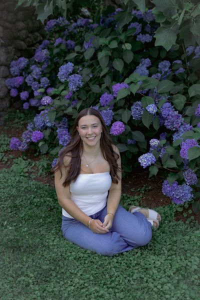 High school senior smiling during outdoor portrait session in Andover, MA