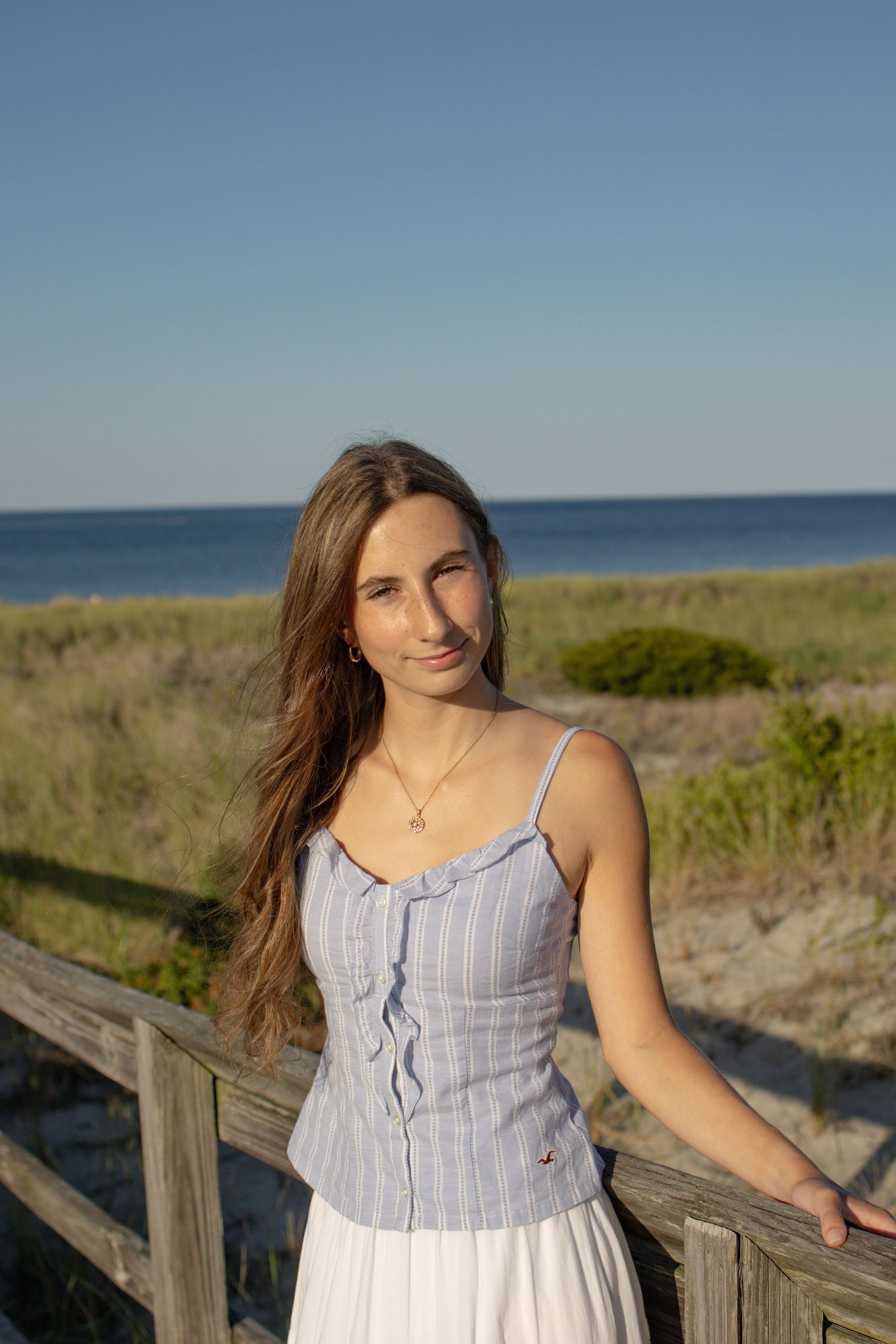 Senior posing for a photo at Crane beach in Ipswich, MA.