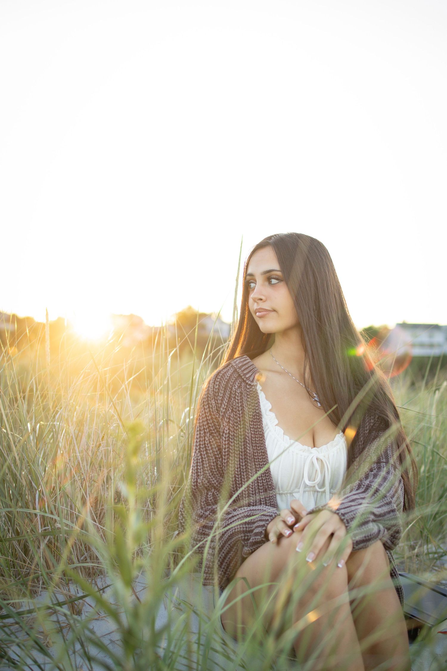 Senior posing at the dunes and high grass at beach in Gloucester.