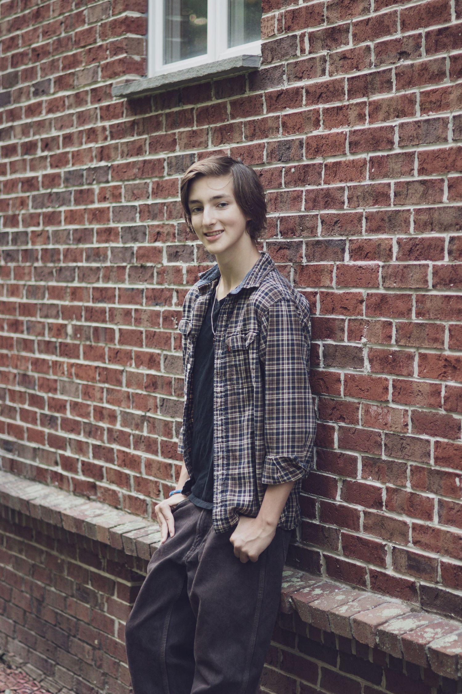 Andover children’s photographer capturing a natural outdoor portrait of a teenage boy surrounded by soft, warm light.