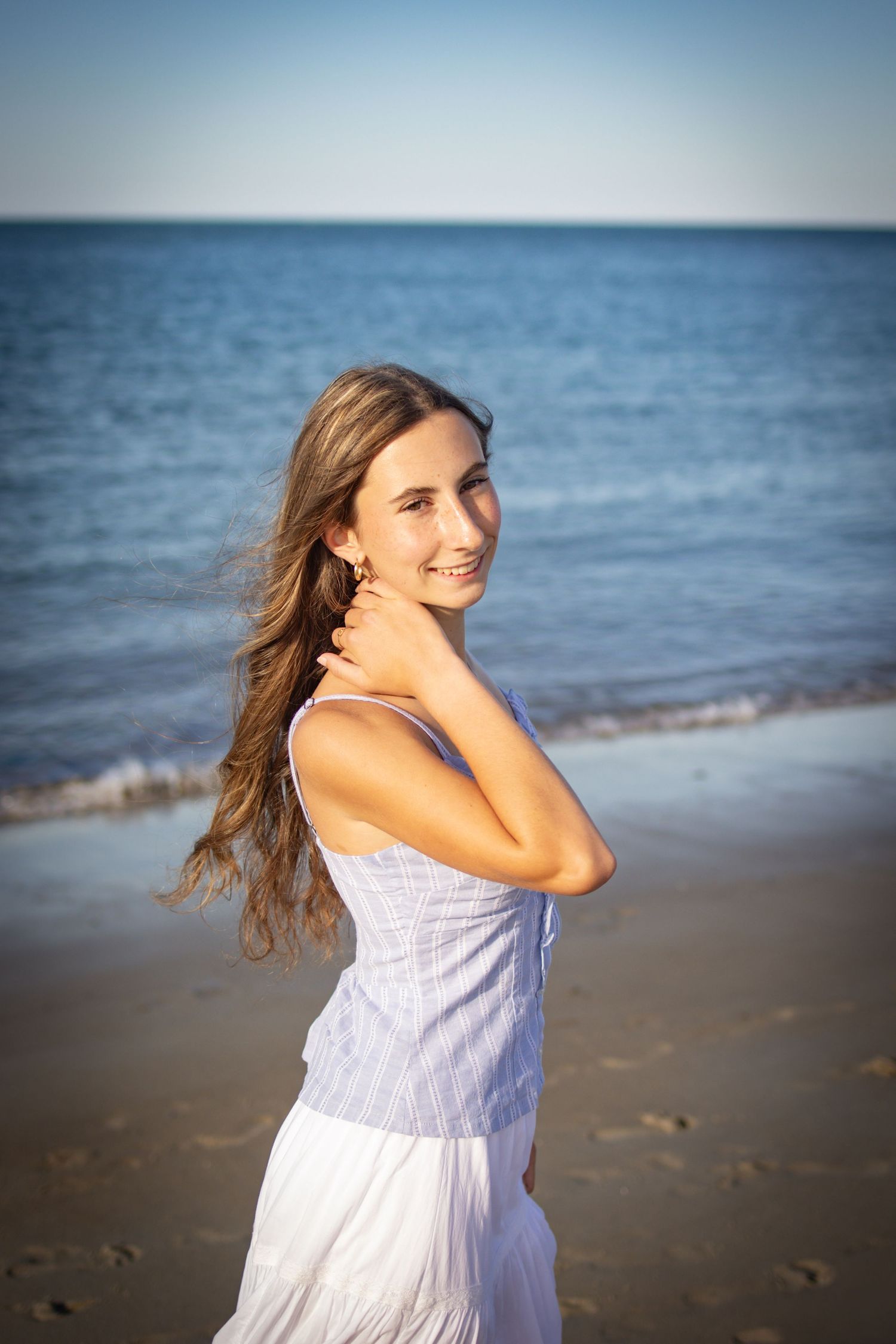 Senior posing for a photo at Crane beach in Ipswich, MA.
