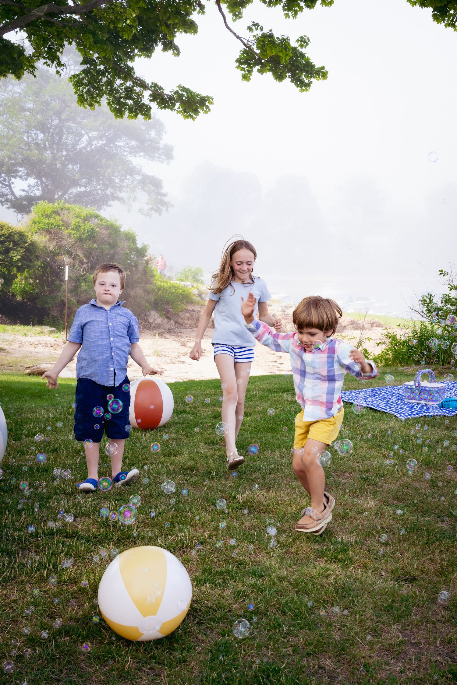 Kids posing for a photo in a picnic setting at Tucks Point in Manchester-by-the-sea.