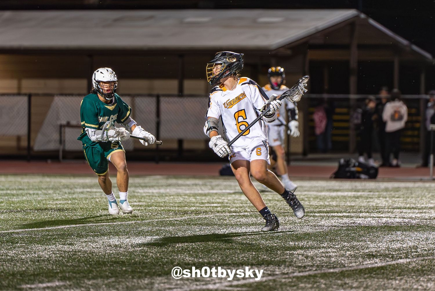 Action shot of an East County Lacrosse player during a competitive match.