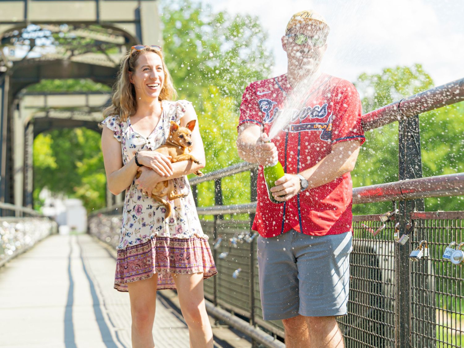 Celebratory moment with confetti and champagne on an outdoor walkway.