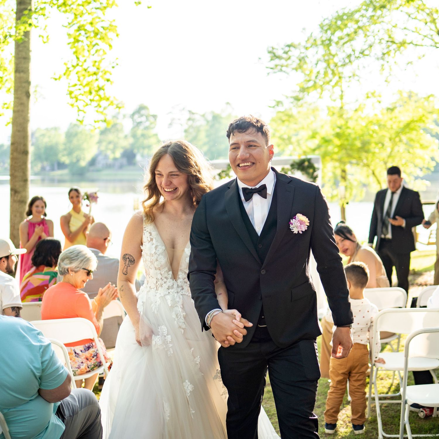 Wedding celebration sequence showing joyful moments at an outdoor lakeside venue.
