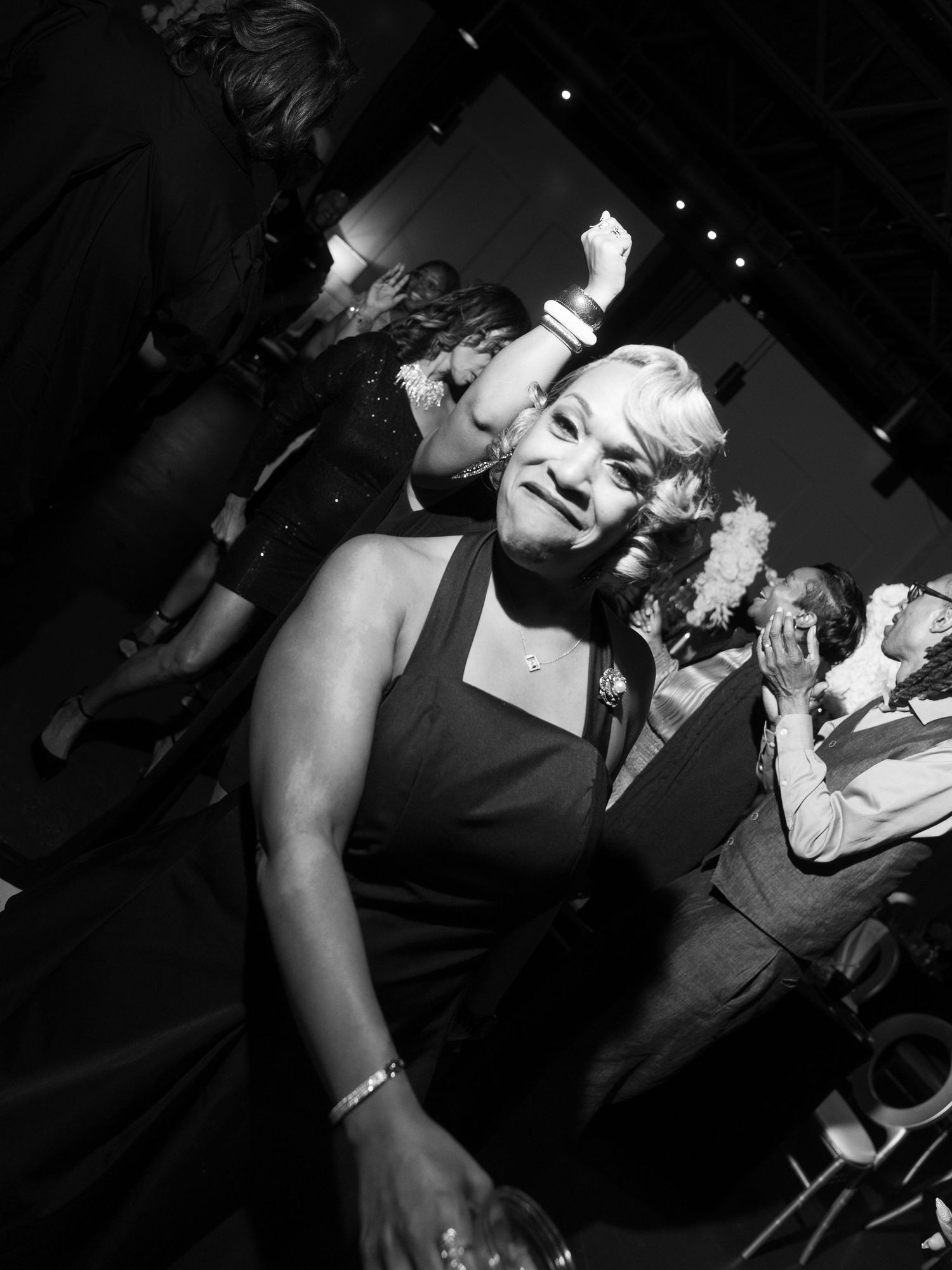 Black and white party photos showing people dancing and celebrating in a dark venue.